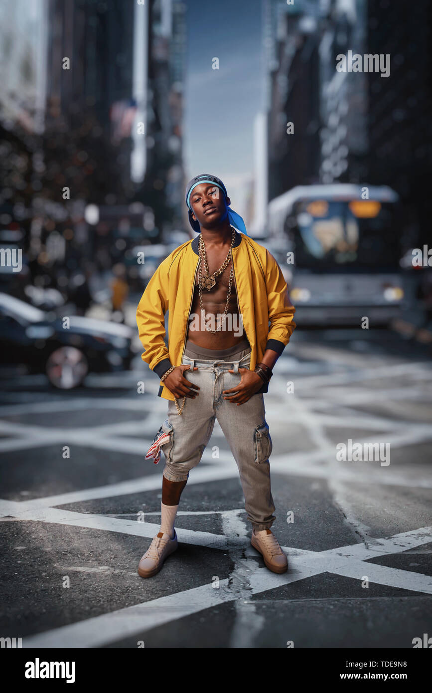 Black rapper on street, cityscape on background Stock Photo