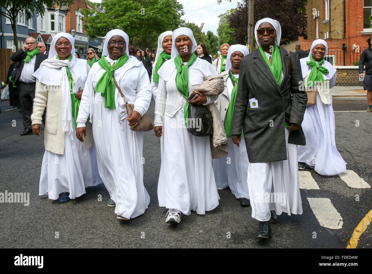London, UK. 14th June, 2019. Nuns wearing symbolic green scarf outside