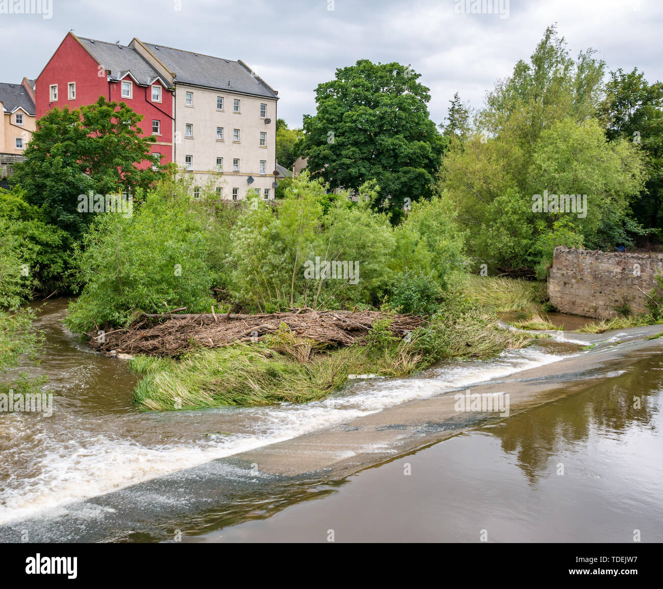 River Tyne path, East Lothian, Scotland, United Kingdom, 15th June 2019. UK Weather: Tyne River path with flood damage and piled debris at a weir in Haddington Stock Photo