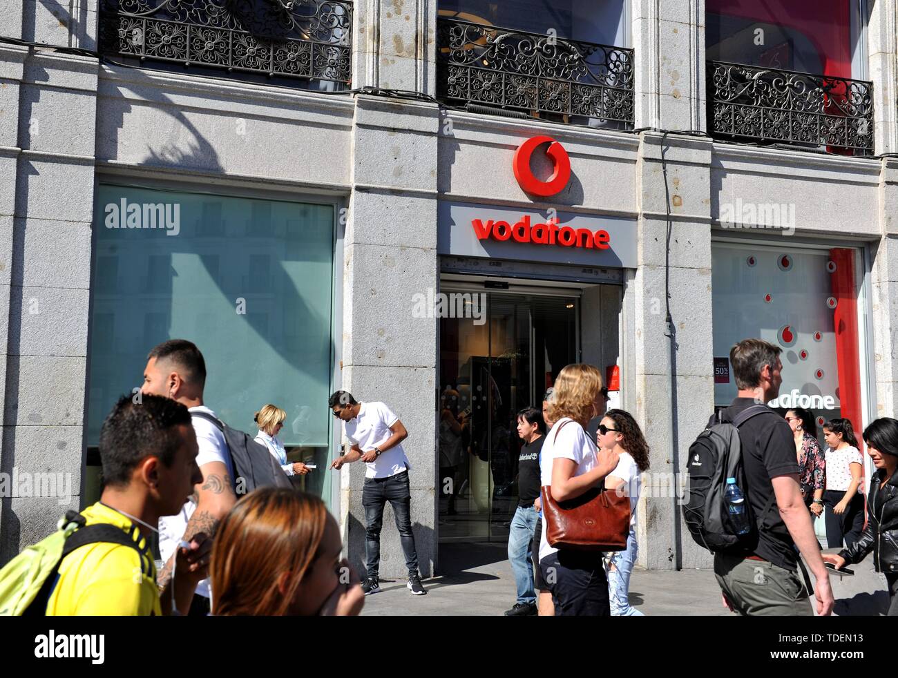 Madrid, Spain. 15th June, 2019. Pedestrians walk past a store of Vodafone Espana in Madrid, Spain, on June 15, 2019. In cooperation with Chinese telecom giant Huawei, Vodafone Espana on Saturday rolled out the first commercial 5G mobile services in Spain, making it one of the first European countries with the ultrafast mobile network in Europe. Credit: Guo Qiuda/Xinhua/Alamy Live News Stock Photo