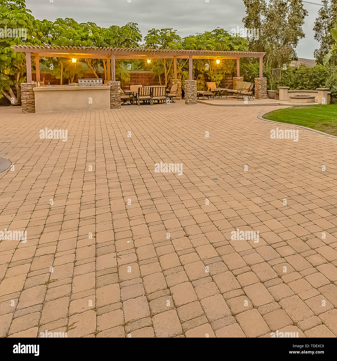 Square Stone Brick Driveway And Patio With Fire Pit And Dining