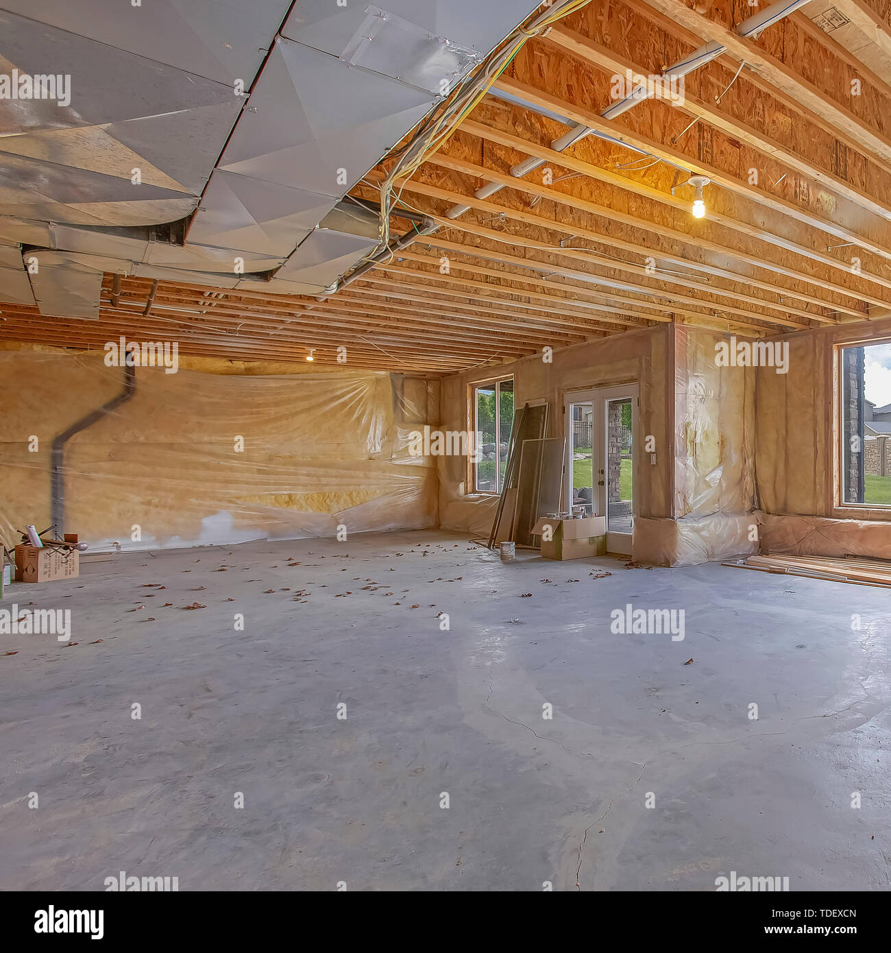 Square Unfinished house interior with air conditioning ducts and glass