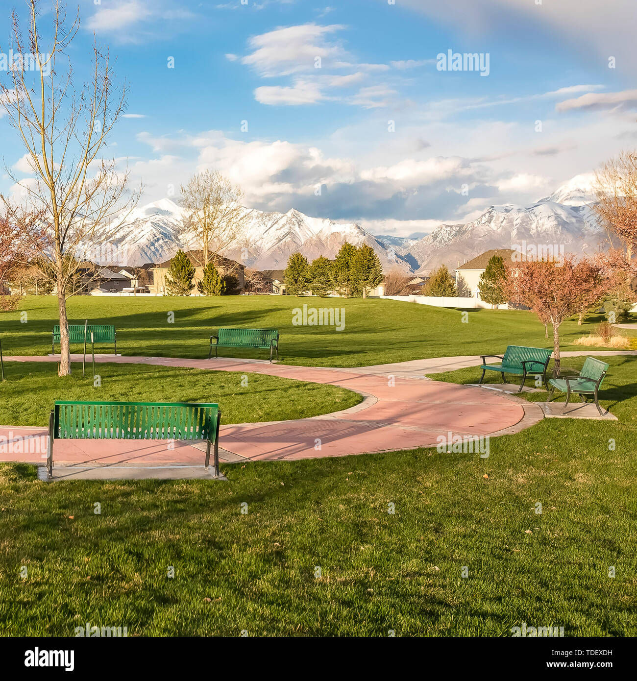 Square Frame Green Benches Around A Circular Pathway On A Park