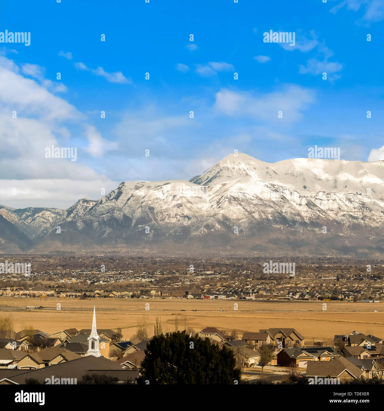 Square Houses and buildings on a vast valley under bright blue sky with