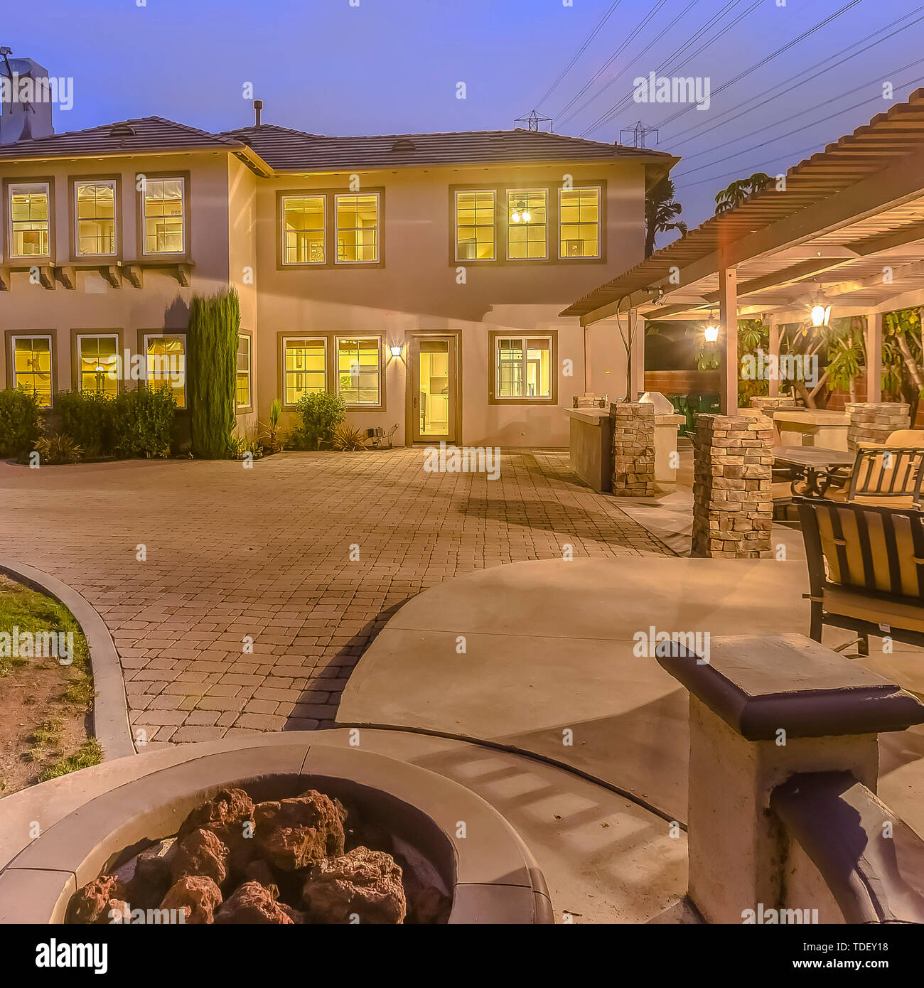 Square Illuminated House With A Patio Accomodating An Outdoor