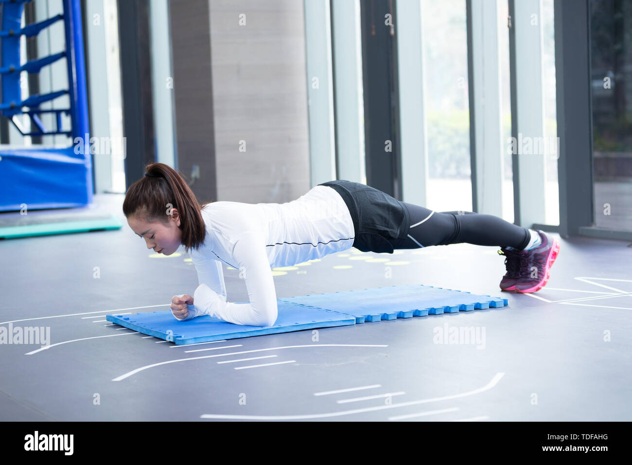 young asian girl doing yoga in modern gym Stock Photo - Alamy