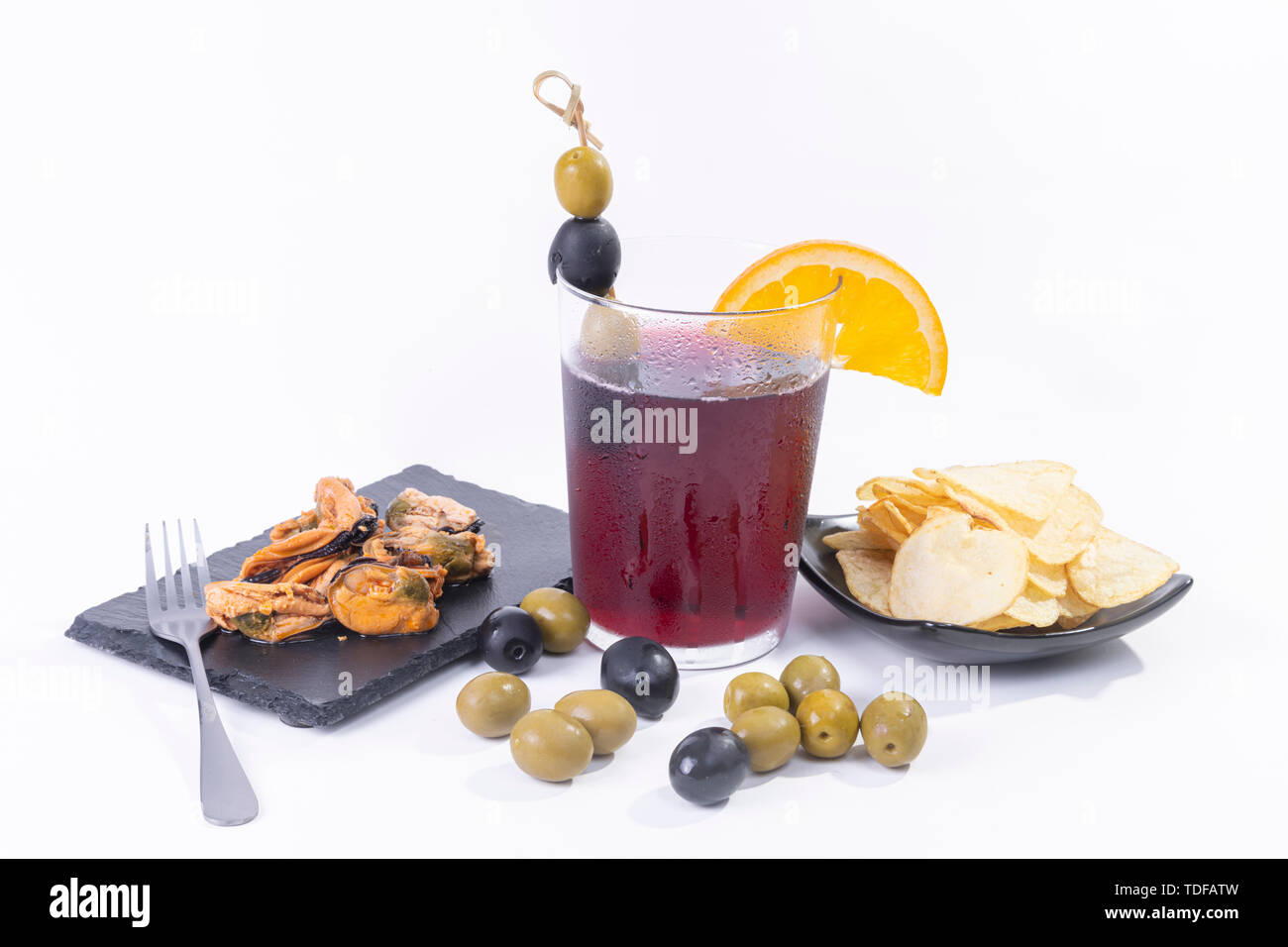 Traditional spanish appetizer with vermouth drink, mussels, potato chips and olives on white