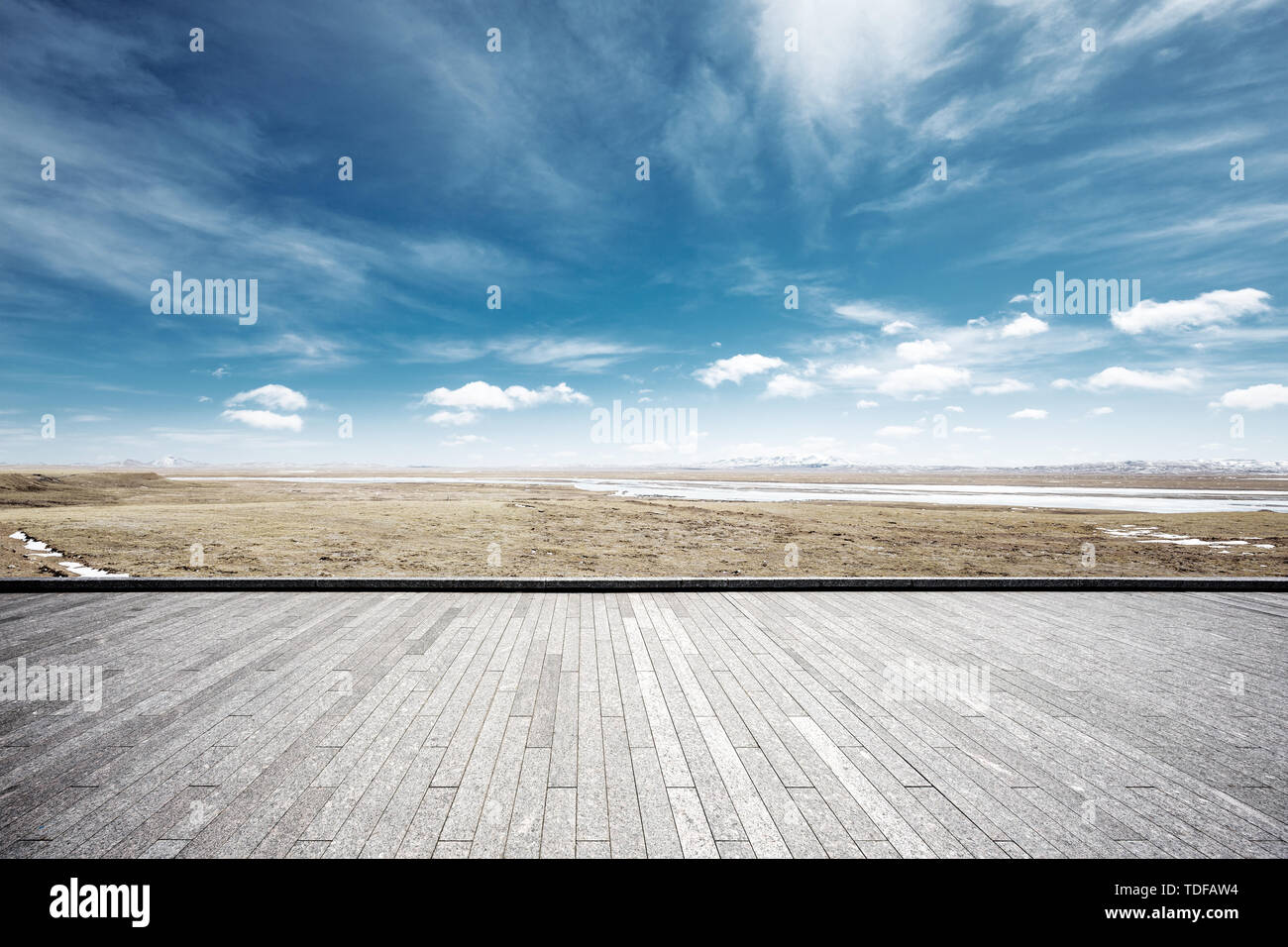 Empty brick floor with snow mountains Stock Photo