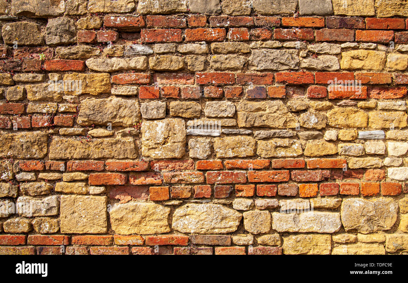 Detail of a brick and Cotswold stone wall, Cotswolds, England Stock