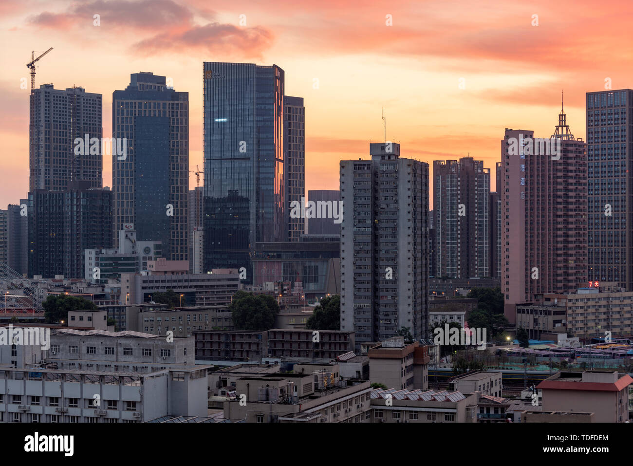 On May 11, 2019, the air quality in Zhengzhou, Henan Province improved, and a long-lost fire cloud landscape appeared in the early morning, matching with staggered high-rise buildings in the railway station area, which appeared extremely spectacular. Stock Photo