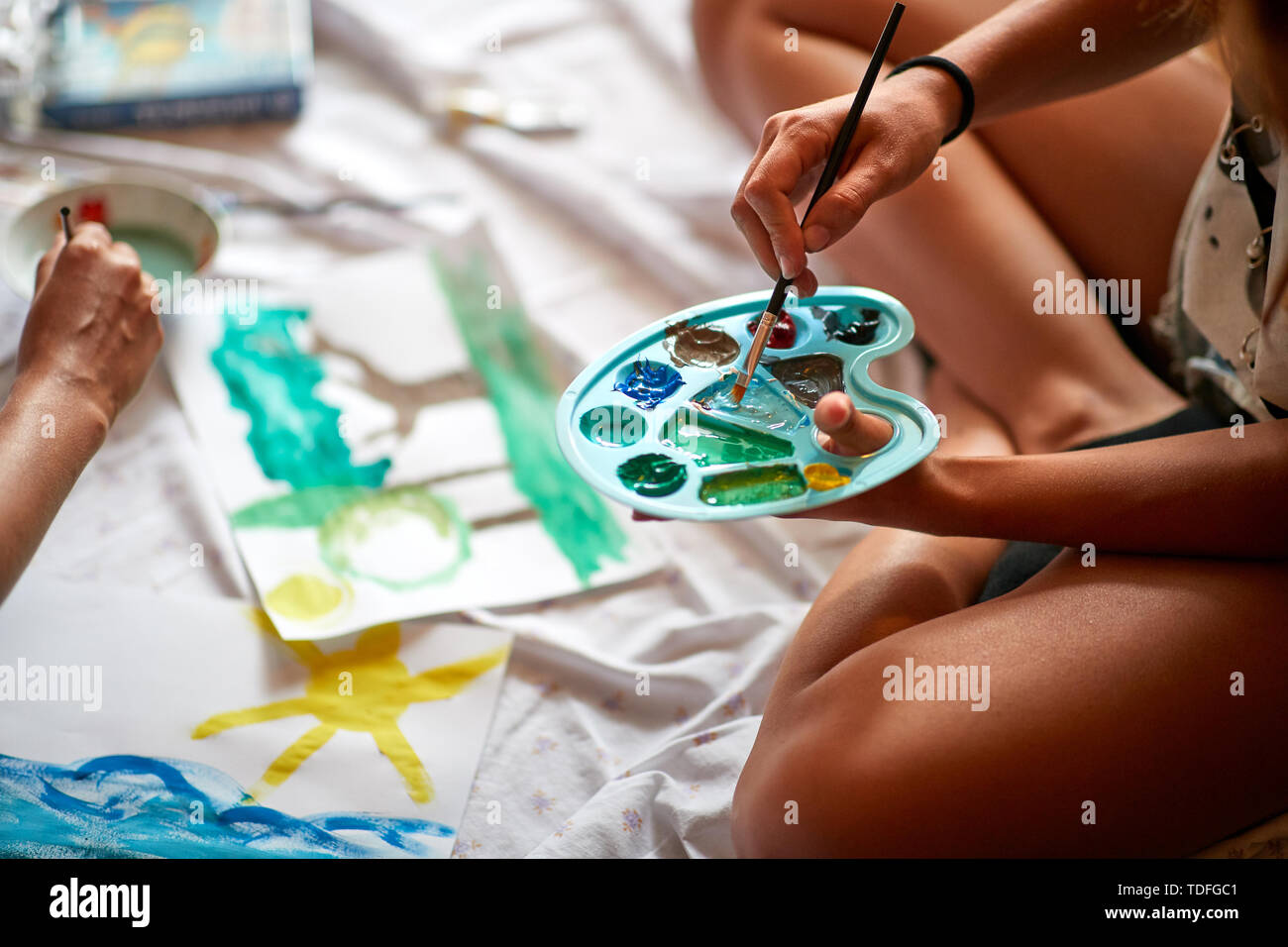 Girl holding palette with paints and brush, concept Stock Photo - Alamy