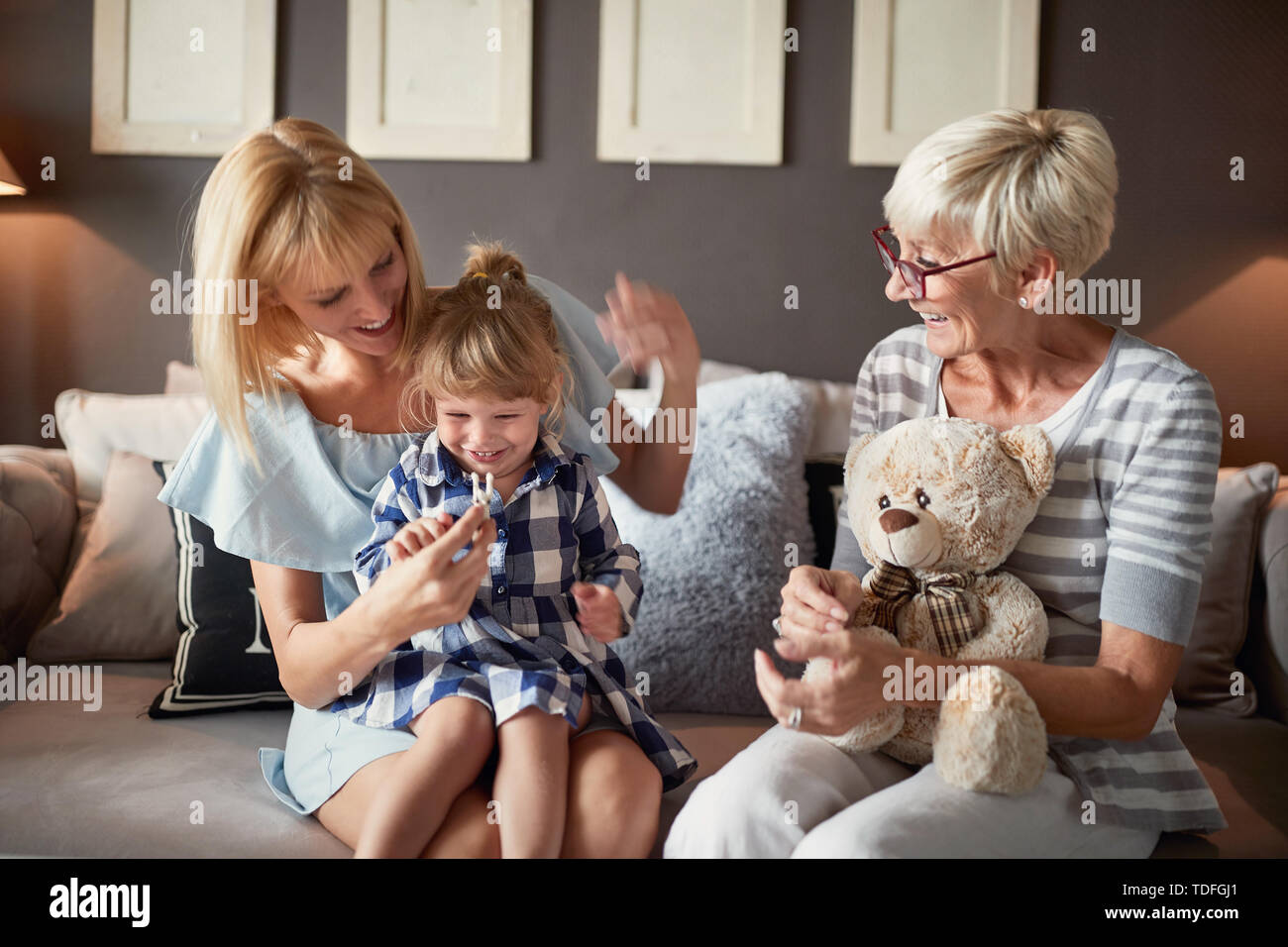 Mom and grandma having fun with cute little girl Stock Photo - Alamy