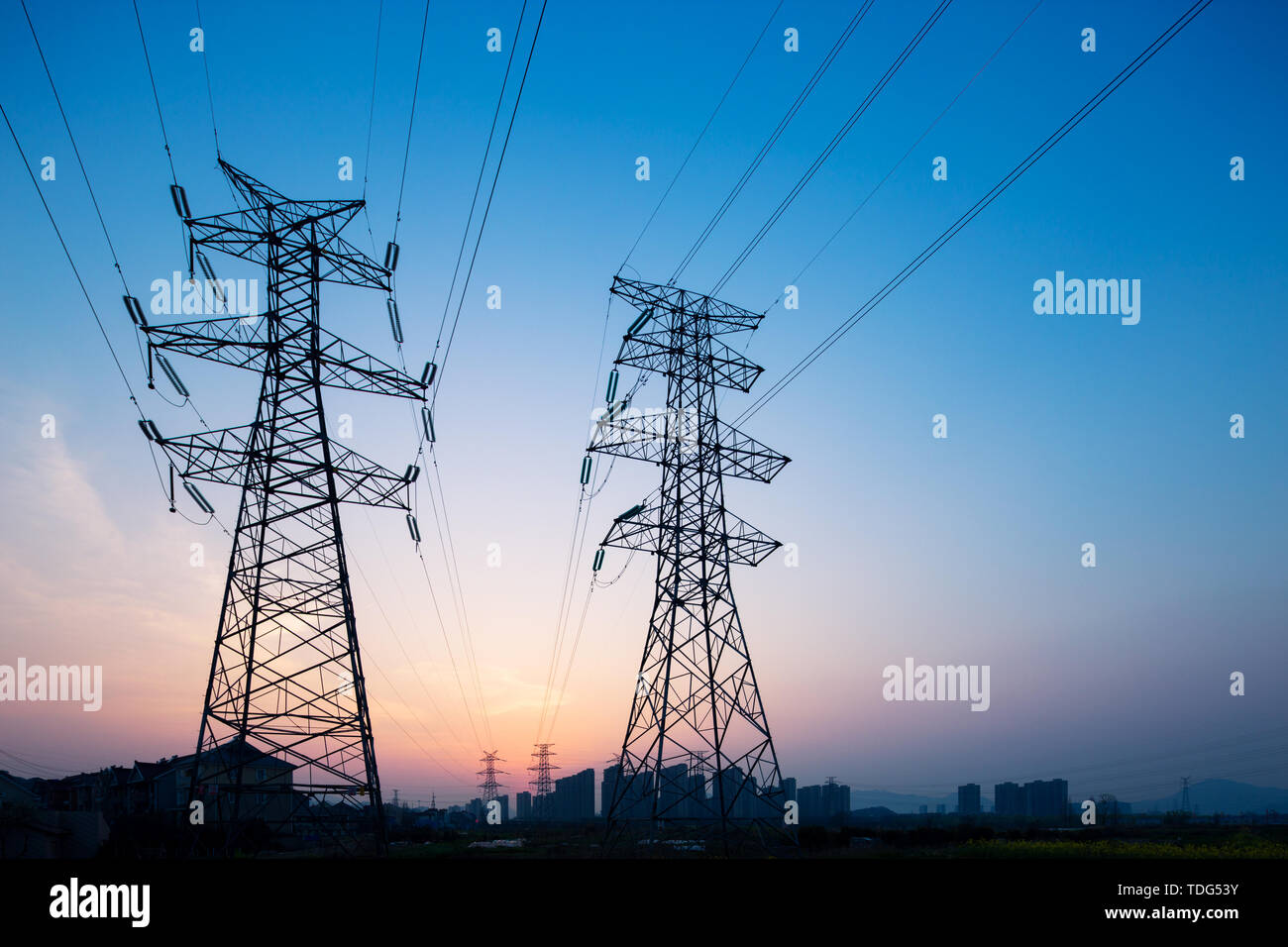Pylons in blue sky at sunrise Stock Photo - Alamy