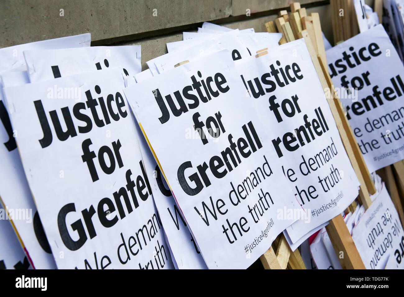 Justice for Grenfell placards seen during the Justice for Grenfell Solidarity rally against the lack of action by the Government following the Grenfell Tower fire, in rehousing affected families, delays in the Public Inquiry, tower blocks still covered in flammable cladding, soil contamination and the performance of Royal Borough of Kensington and Chelsea. On 14 June 2017, just before 1:00 am a fire broke out in the kitchen of the fourth floor flat at the 24-storey residential tower block in North Kensington, West London, which took the lives of 72 people. More than 70 others were injured and  Stock Photo