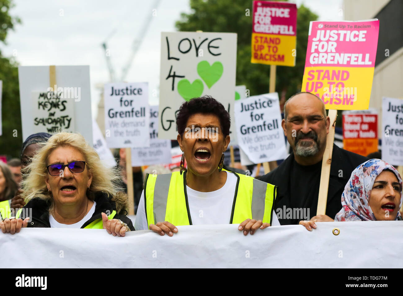 Campaigners shout slogans during the Justice for Grenfell Solidarity rally against the lack of action by the Government following the Grenfell Tower fire, in rehousing affected families, delays in the Public Inquiry, tower blocks still covered in flammable cladding, soil contamination and the performance of Royal Borough of Kensington and Chelsea. On 14 June 2017, just before 1:00 am a fire broke out in the kitchen of the fourth floor flat at the 24-storey residential tower block in North Kensington, West London, which took the lives of 72 people. More than 70 others were injured and 223 peopl Stock Photo