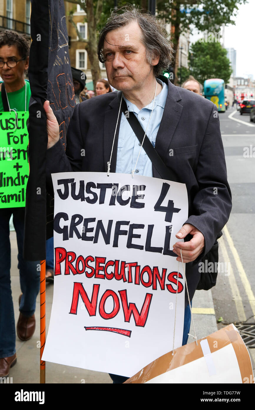 A campaigner holds a placard during the Justice for Grenfell Solidarity rally against the lack of action by the Government following the Grenfell Tower fire, in rehousing affected families, delays in the Public Inquiry, tower blocks still covered in flammable cladding, soil contamination and the performance of Royal Borough of Kensington and Chelsea. On 14 June 2017, just before 1:00 am a fire broke out in the kitchen of the fourth floor flat at the 24-storey residential tower block in North Kensington, West London, which took the lives of 72 people. More than 70 others were injured and 223 pe Stock Photo