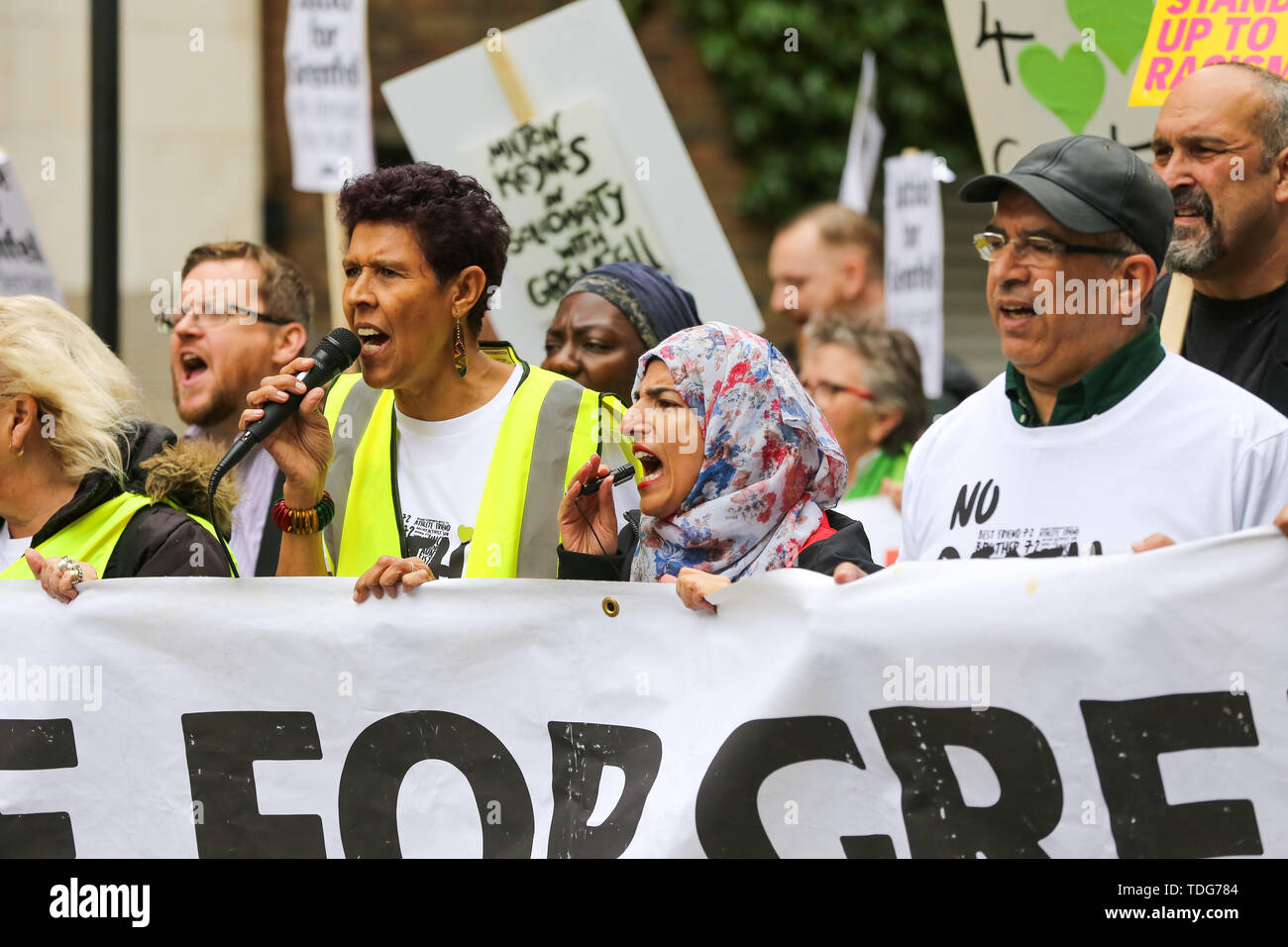 Campaigners shout slogans during the Justice for Grenfell Solidarity rally against the lack of action by the Government following the Grenfell Tower fire, in rehousing affected families, delays in the Public Inquiry, tower blocks still covered in flammable cladding, soil contamination and the performance of Royal Borough of Kensington and Chelsea. On 14 June 2017, just before 1:00 am a fire broke out in the kitchen of the fourth floor flat at the 24-storey residential tower block in North Kensington, West London, which took the lives of 72 people. More than 70 others were injured and 223 peopl Stock Photo