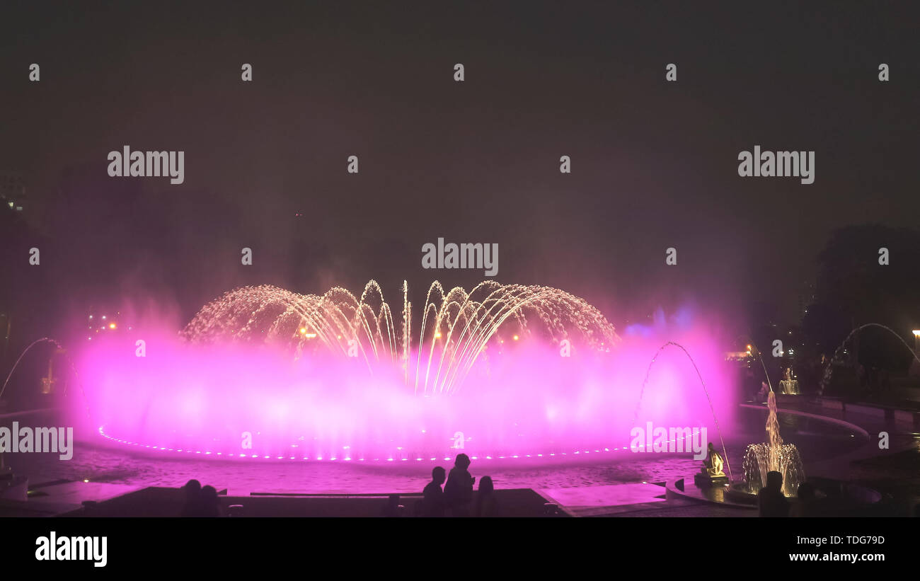 magic fountain with pink lighting changing to orange in lima, peru Stock Photo