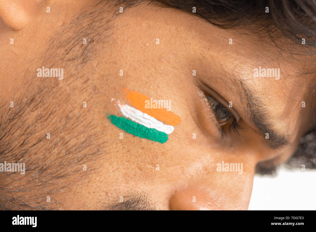 Closeup of a Tricolor Indian flag Painted on face to cheer India in cricket sports Stock Photo