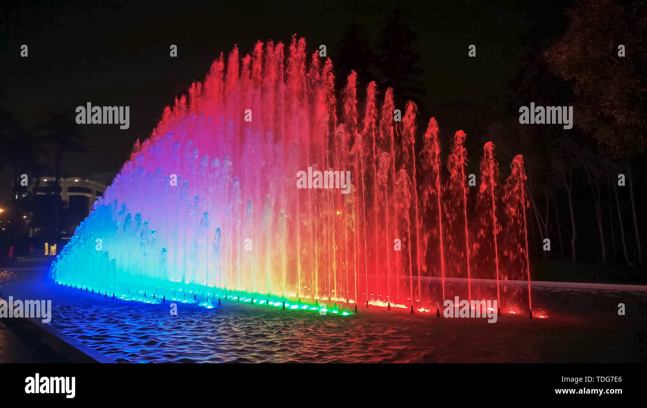 night shot of the colorful rainbow fountain at the park of the reserve in lima, peru Stock Photo
