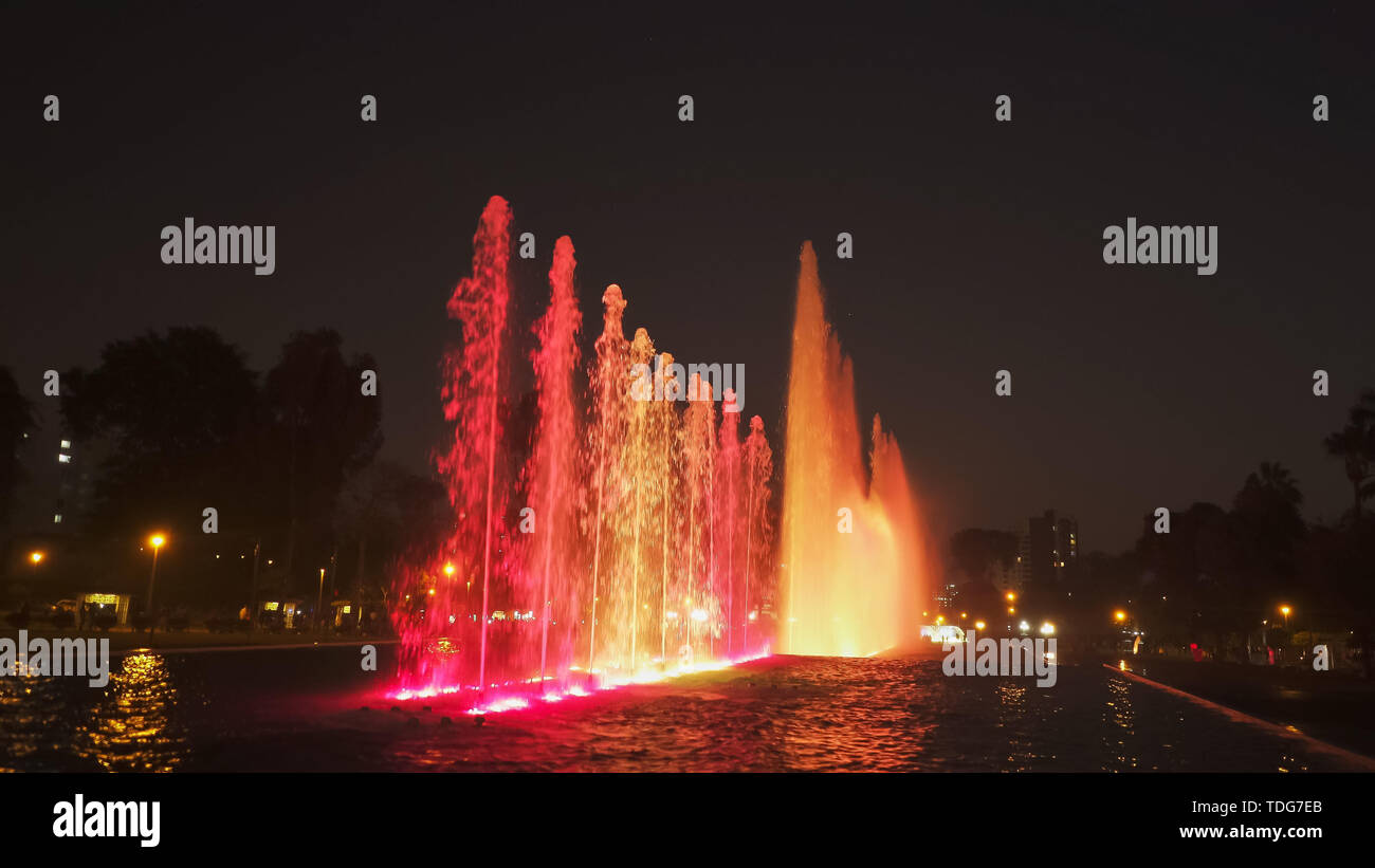 red lighting on the magic water circuit fountain in lima, peru Stock Photo