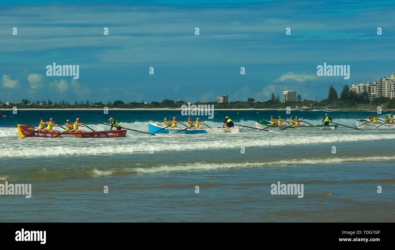 ALEXANDRA HEADLAND, QUEENSLAND, AUSTRALIA- APRIL 22, 2016: wide shot of the start of a men's surf boat race during a surf life saving competition in q Stock Photo