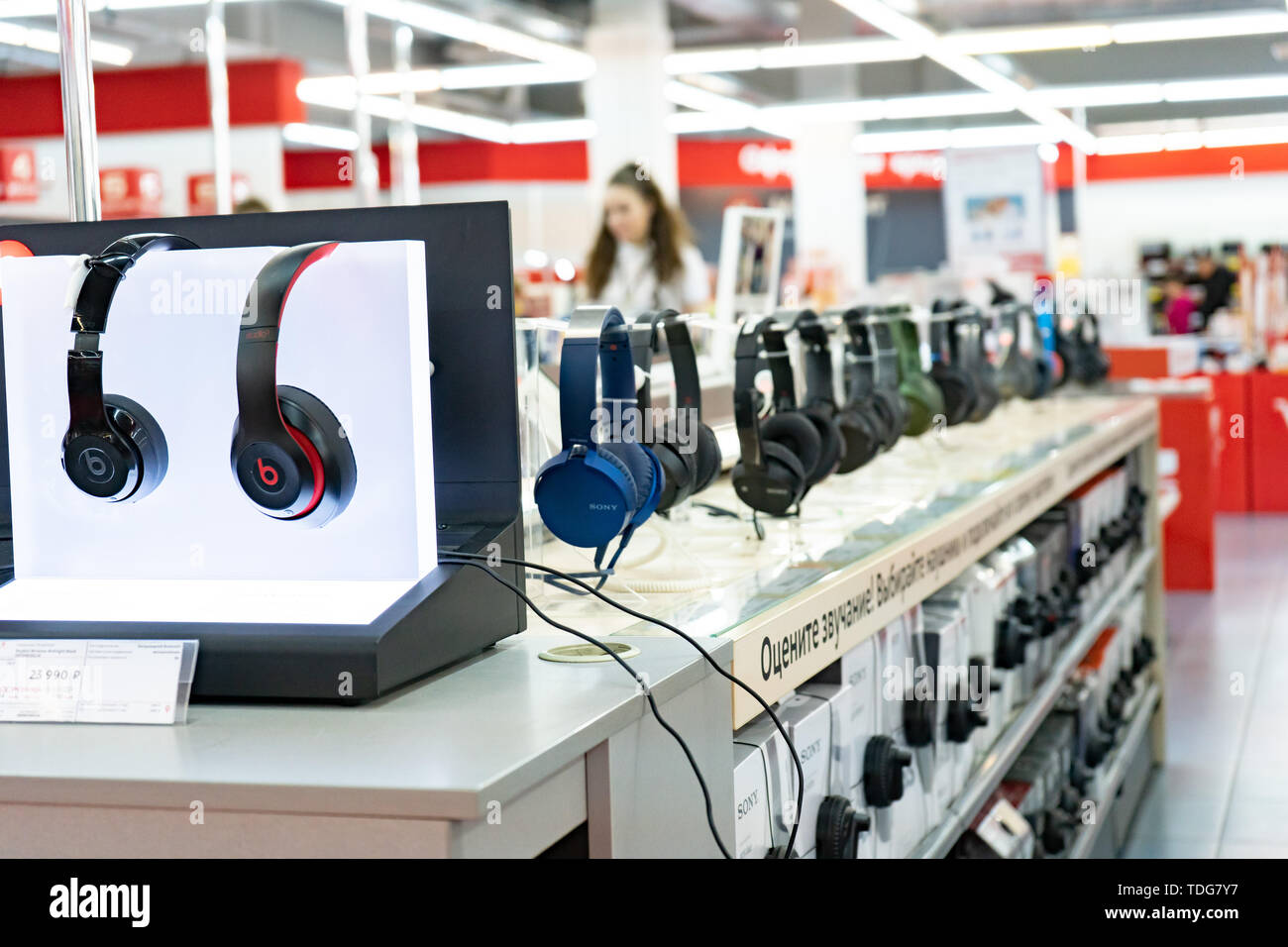 Chelyabinsk Region, Russia - June 2019. Household electrical appliances store M Video. Shelving with goods. Stereo headphones Stock Photo