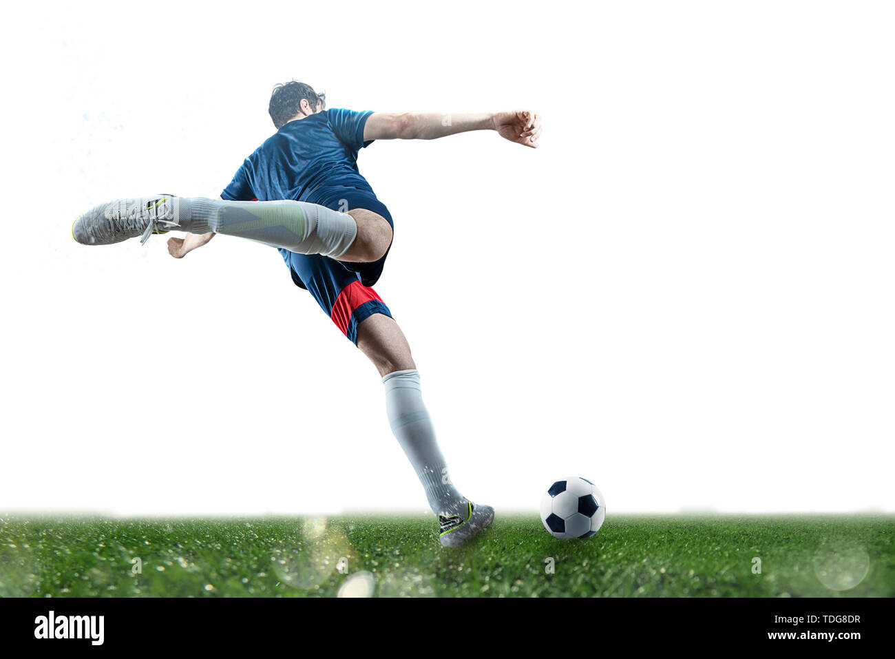 Football scene at night match with player kicking the ball with power Stock Photo Alamy