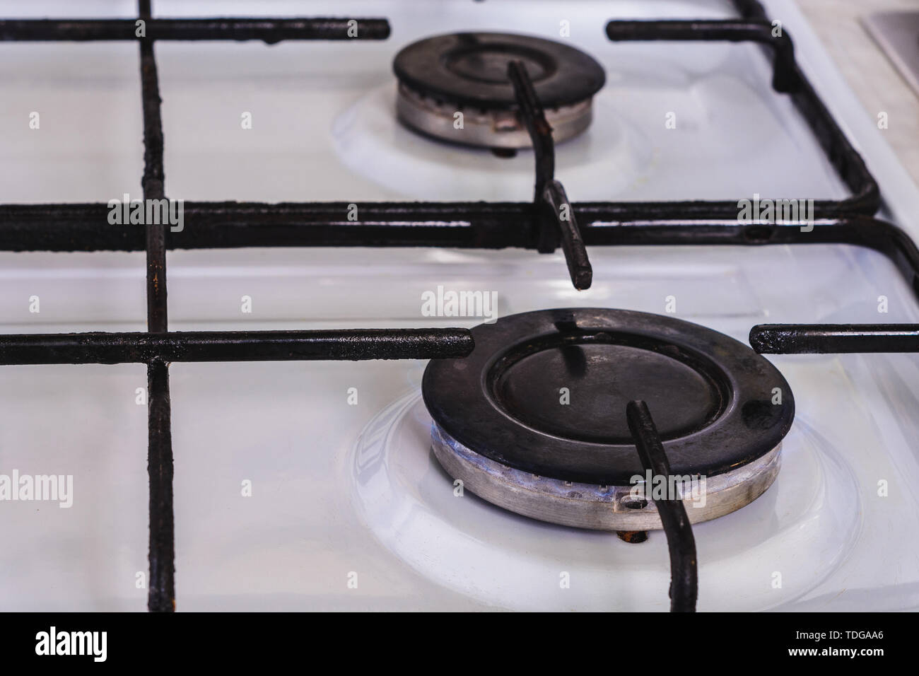 On the white gas stove the burner is lit from which the flame of