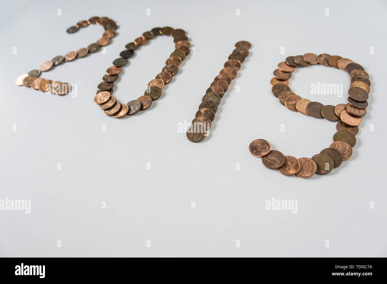 2019 Year made of isolated bronze penny coins on blank white background w/ empty room space for text, copy, or copyspace. This current now present wit Stock Photo