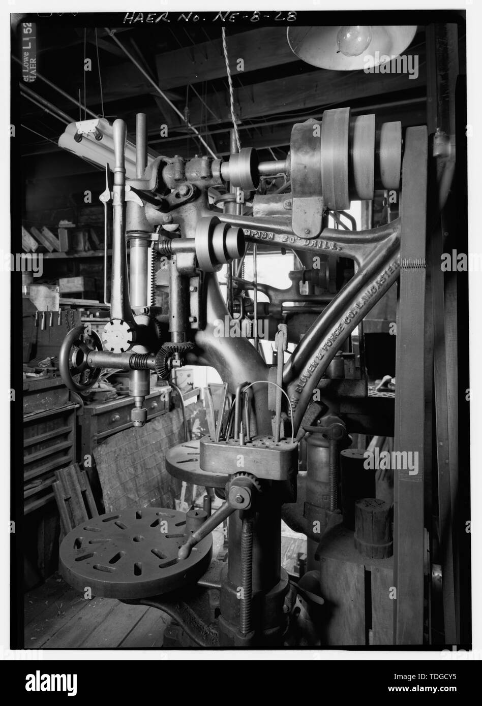 NORTH TO DETAIL OF CIRCA 1900 CHAMPION 20' DRILL PRESS MADE BY CHAMPION BLOWER AND FORGE CO. ALONG EAST INTERIOR WALL AT NORTHEAST CORNER OF FACTORY BUILDING. - Kregel Windmill Company Factory, 1416 Central Avenue, Nebraska City, Otoe County, NE Stock Photo