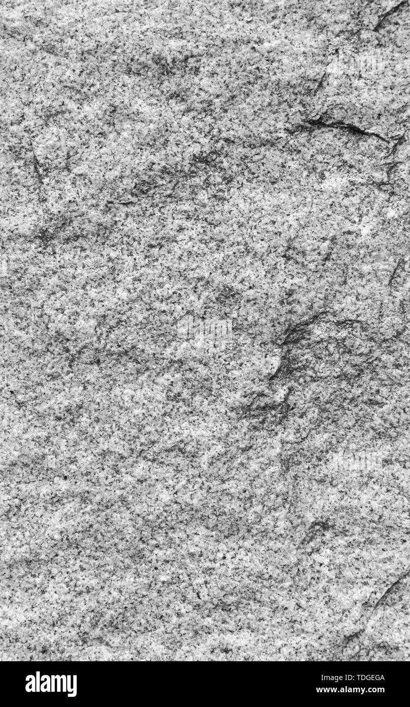 Close-up of white, fine-grained granite surface in black and white. High resolution full frame texture background. Stock Photo