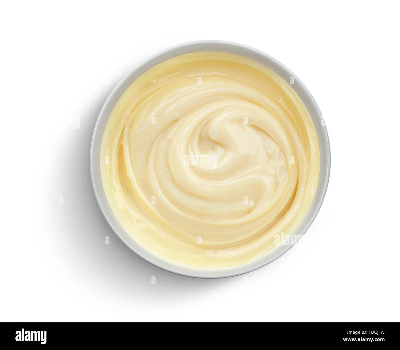 Bowl of condensed milk isolated on white background, top view Stock Photo