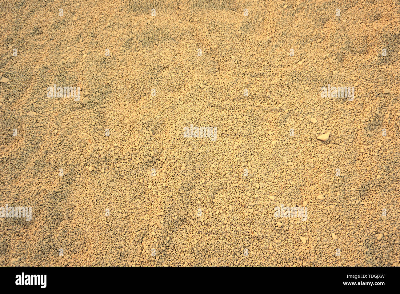 Background in big dimension. Fine gravel in beige color tone, top view. Shadows of the sunset light on the surface Stock Photo
