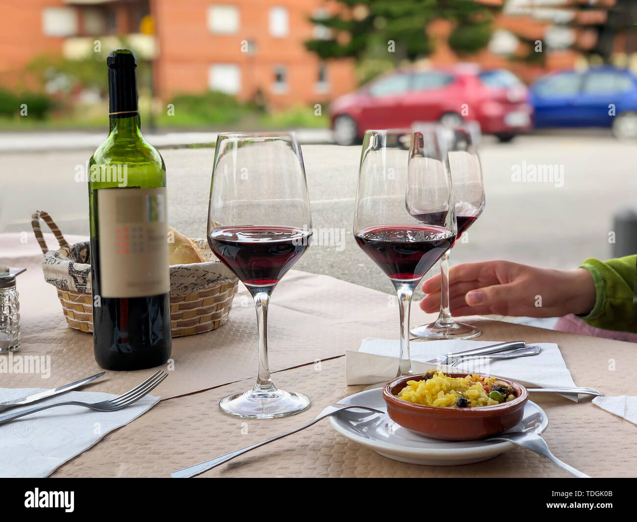 Three glasses of red wine, bottle of wine and chef's compliment, small