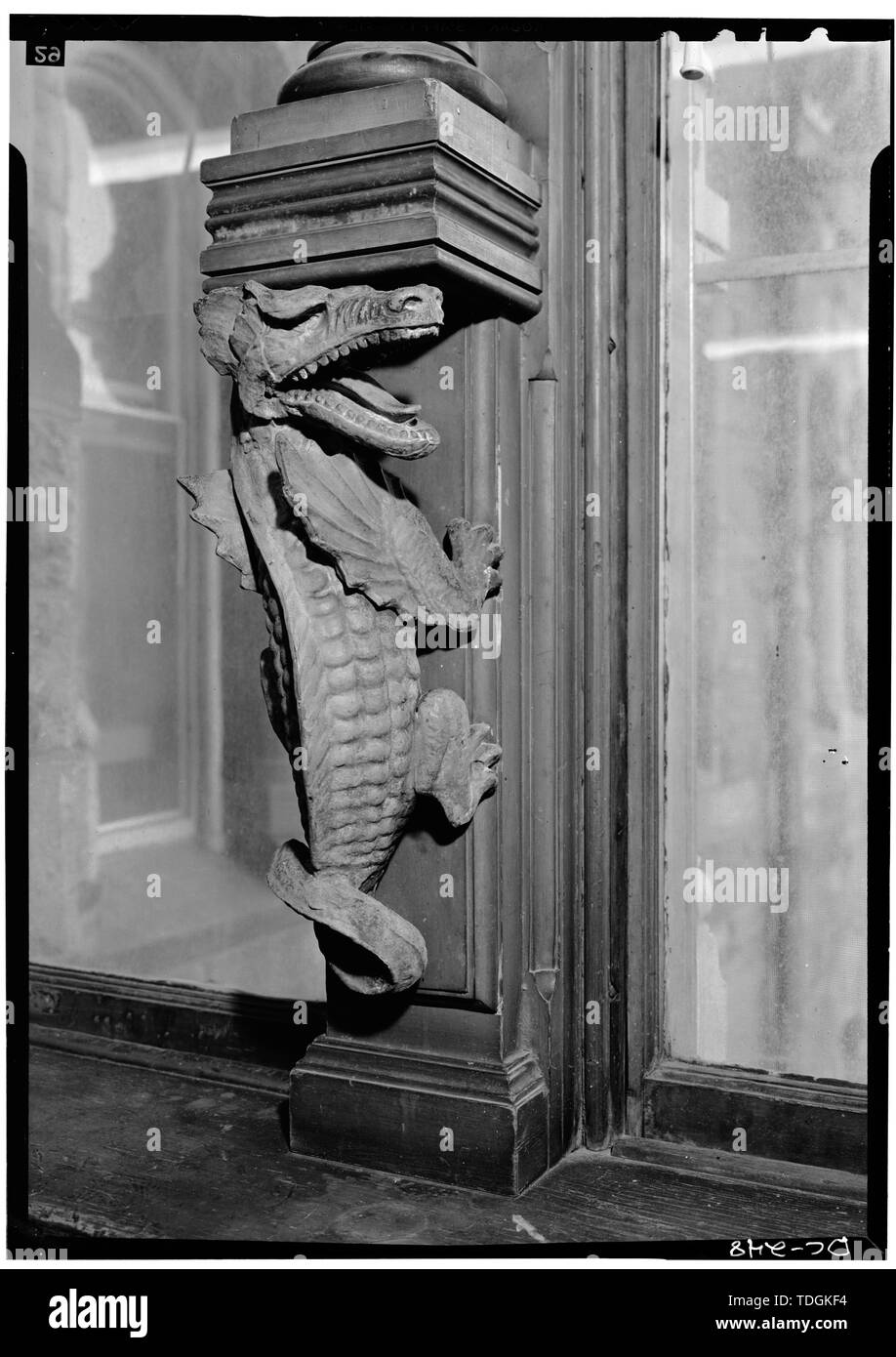November 1969 CAST-IRON DRAGON GROTESQUE BELOW BASE OF COLUMN SEPARATING WINDOWS ON NORTH SIDE OF RIGGS LIBRARY - Georgetown University, Healy Building, Thirty-seventh and O Streets, Northwest, Washington, District of Columbia, DC Stock Photo