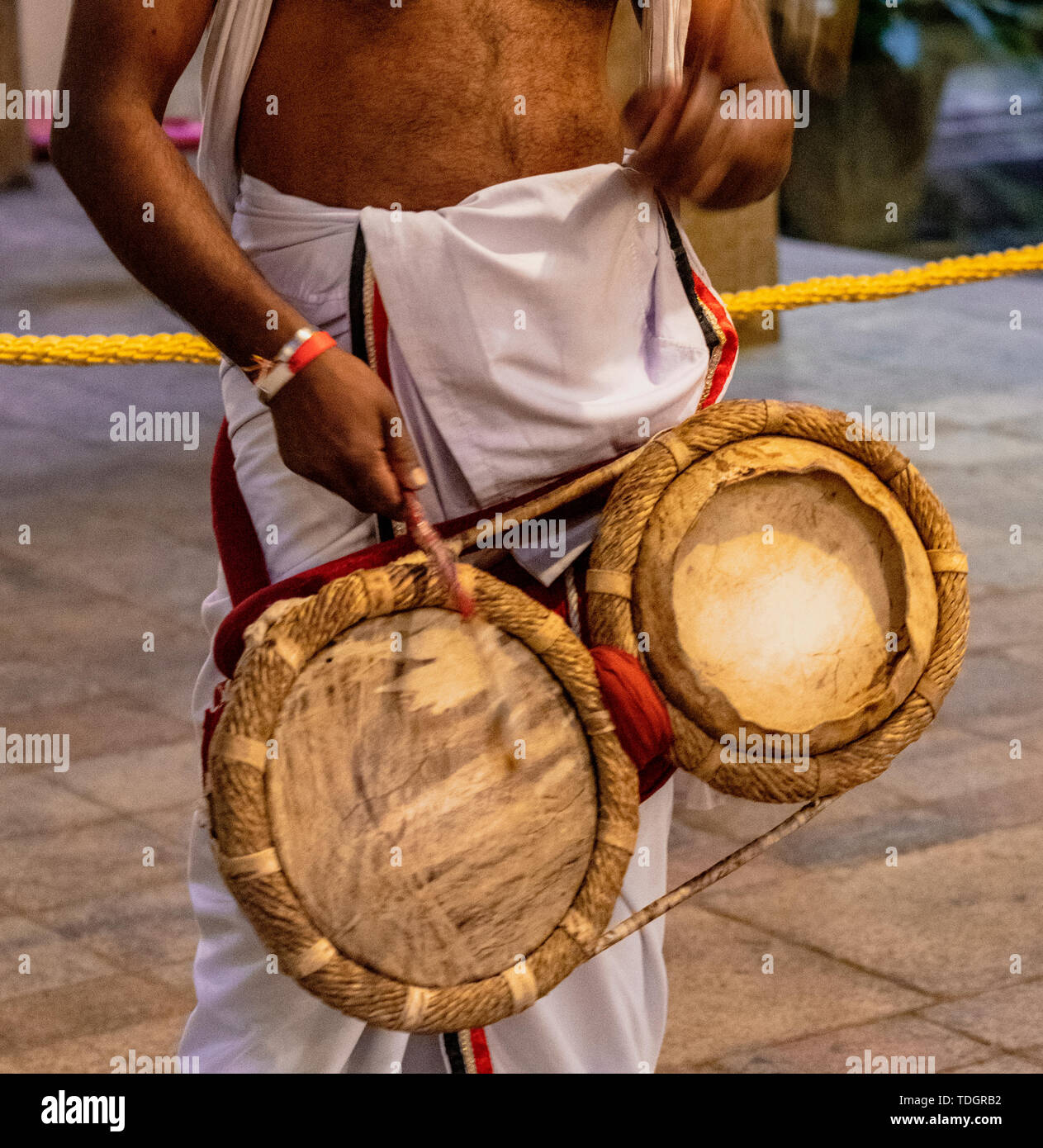 Priest Beats Drums at the Temple of the Tooth Relic in Kandy Sri Lanka. Stock Photo