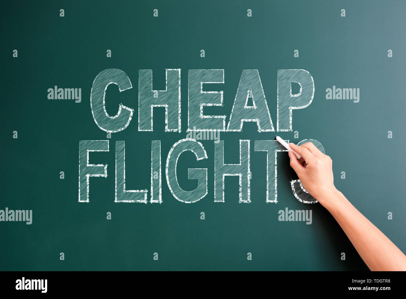 writing cheap flight on blackboard Stock Photo
