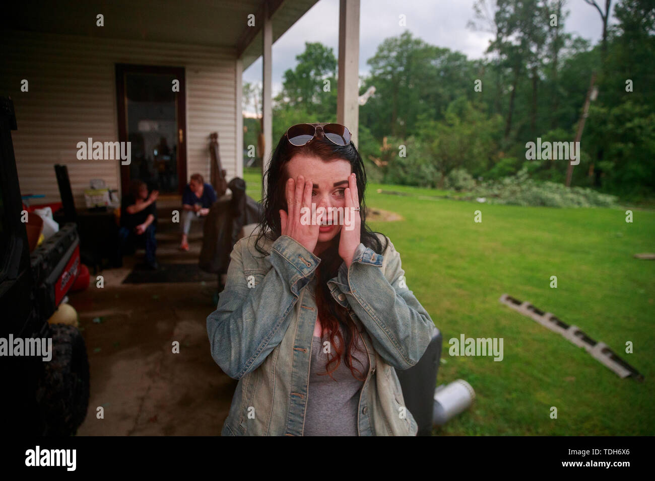 Ellettsville, USA. 17th July, 2019. Nicole Rood reacts after telling how she survived a tornado by holding onto the door handle of a house as she was lifted off the ground in the 6400 block of West Cowden Rd., Saturday, June 16, 2019 near Ellettsville, Ind. Rood's boyfriend Brett Cantrell survived by hanging onto a tree across the road. The couple were in their car when the storm stuck. The tornado destroyed several homes, tore up trees, and left dangerous live power lines scattered around the area. Credit: SOPA Images Limited/Alamy Live News Stock Photo