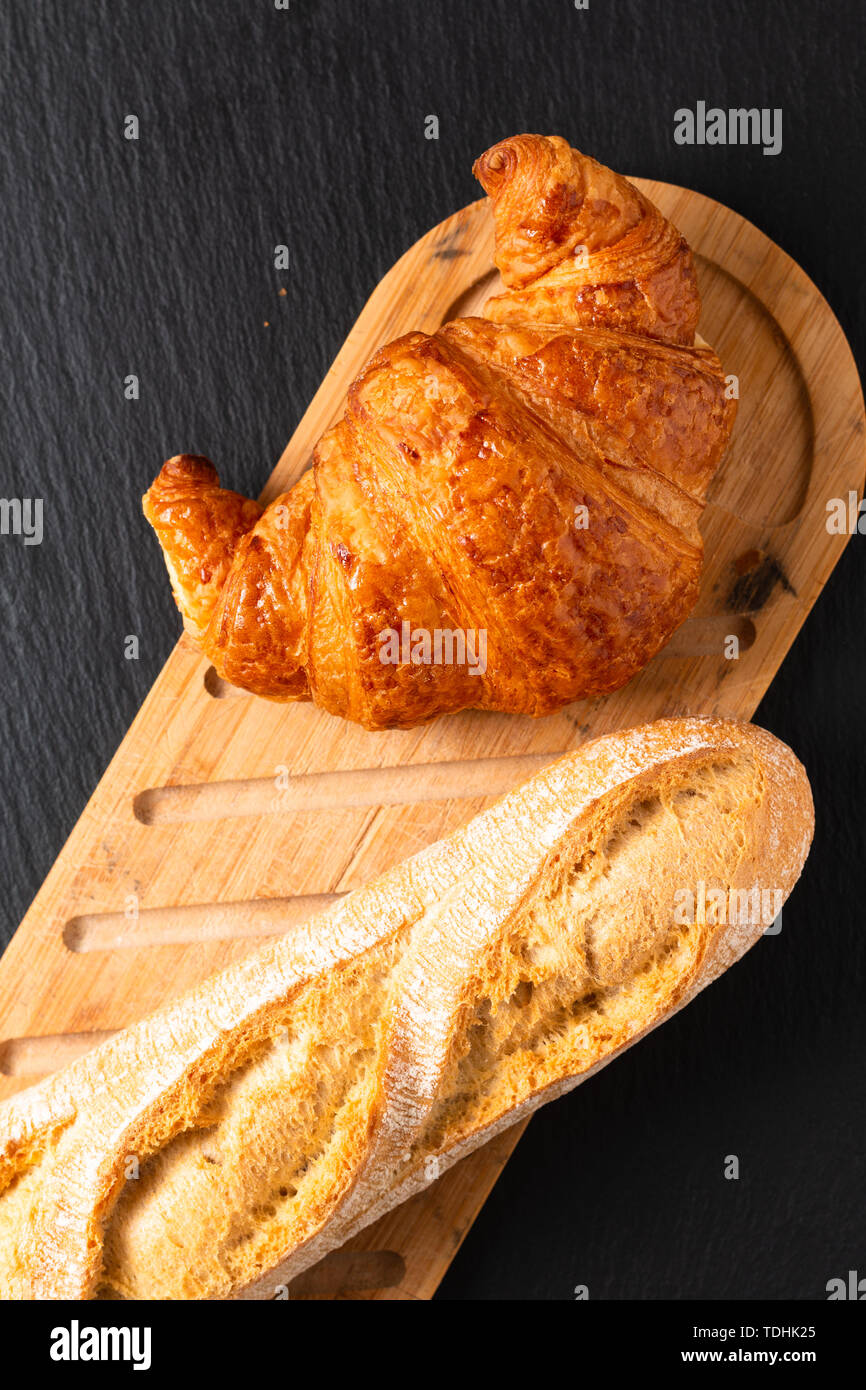 Food concept French croissant on black slate board with copy space Stock Photo