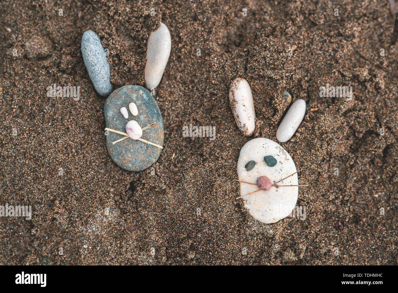 Shape of mice from stones on the beach sand Stock Photo