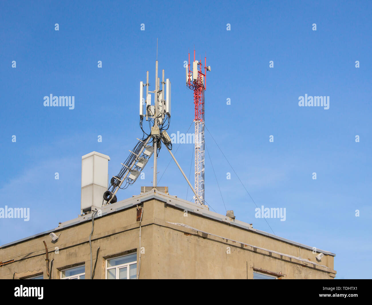 Telecommunication base stations network repeaters on the roof of the building Stock Photo