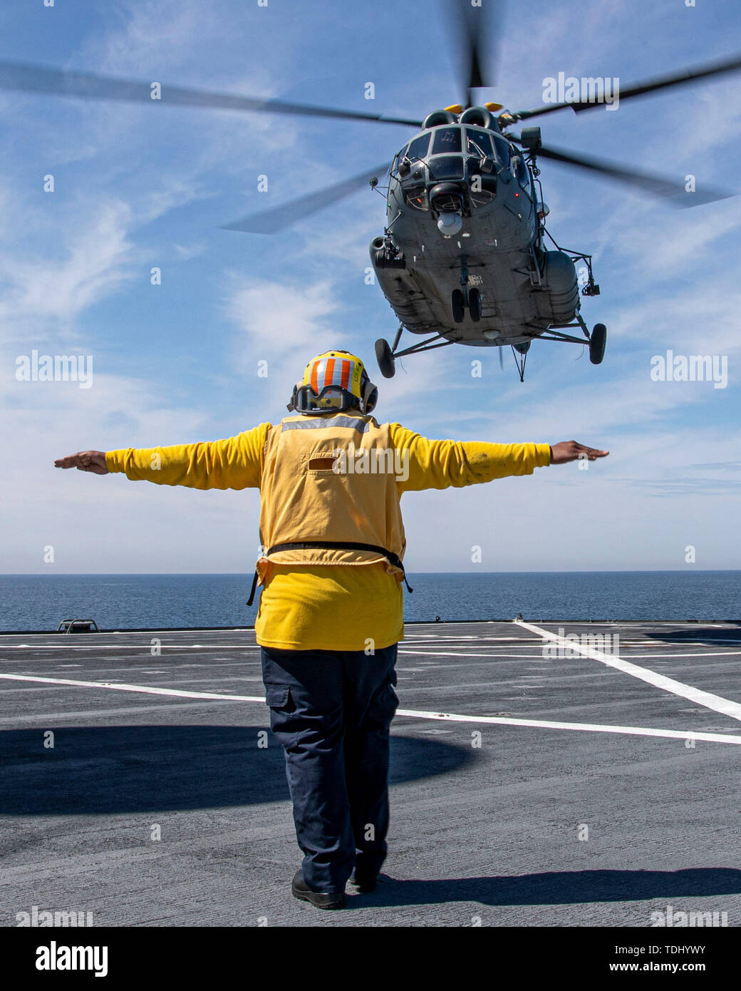 190615-N-EI510-0382 BALTIC SEA (June 15, 2019) A Military Sealift Command civilian mariner assigned to the Blue Ridge class command and control ship USS Mount Whitney (LCC 20) guides a Lithuanian Air Force SAR Mi-8T Helicopter off the flight deck of the Mount Whitney during exercise Baltic Operations (BALTOPS) 2019. BALTOPS is the premier annual maritime-focused exercise in the Baltic Region, marking the 47th year of one of the largest exercises in Northern Europe enhancing flexibility and interoperability among allied and partnered nations.  (U.S. Navy Photo by Mass Communication Specialist 2 Stock Photo