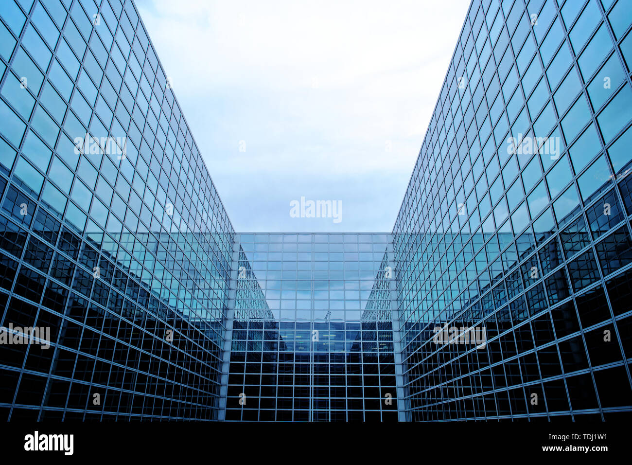 Modern futuristic business building with glass facade. Stock Photo