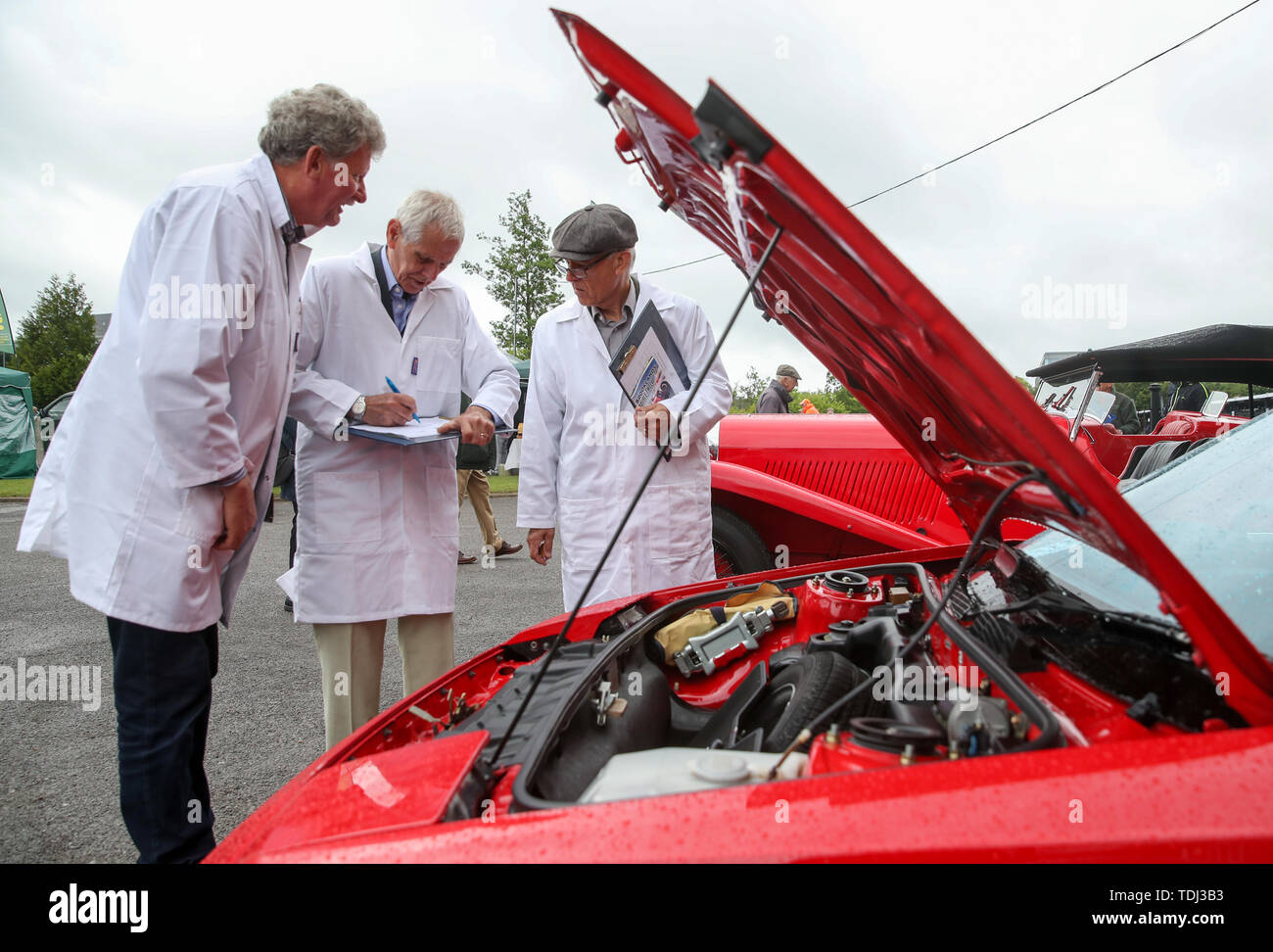 Judges from the VSCC (Vintage Sports Car Club) inspect a 1988 Toyota MR2 Mk1 for the traditional concours d'elegance, during the Brooklands Double Twelve Motorsport Festival at Brooklands Museum, in Weybridge, Surrey. Stock Photo