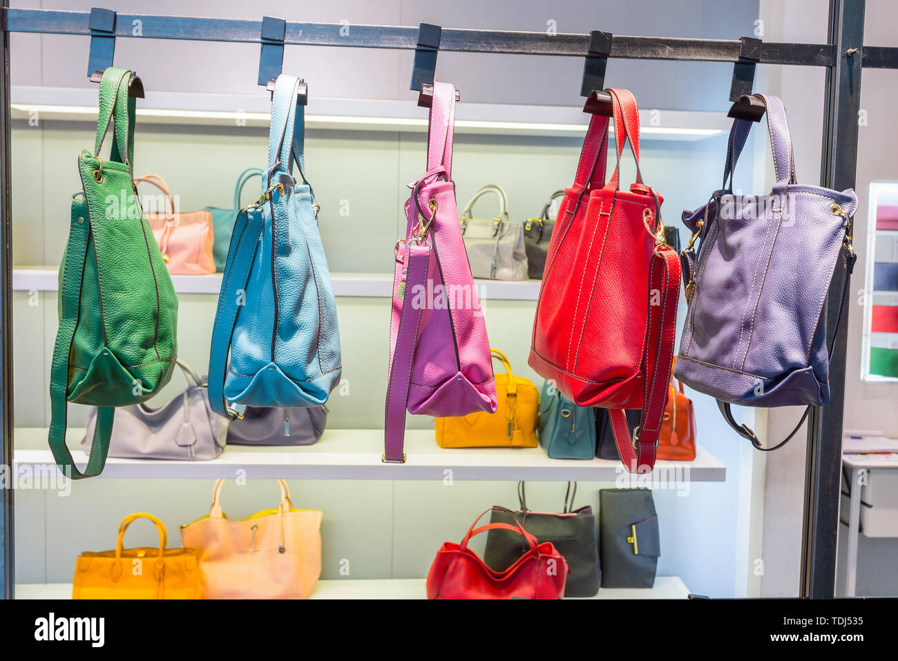 Bags in shop display window Stock Photo - Alamy