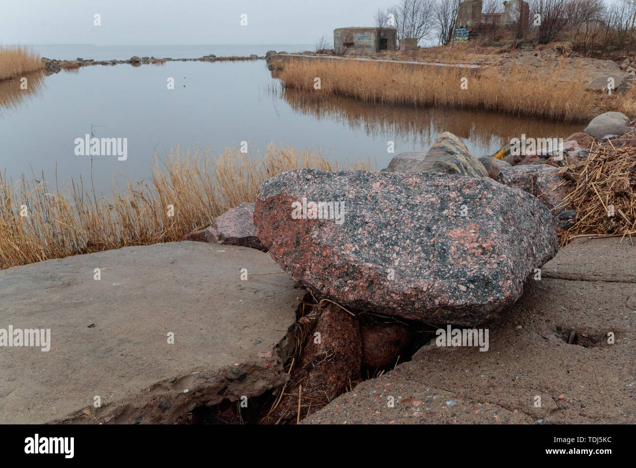 large stones of the destroyed building against the sea and sky in the evening Stock Photo