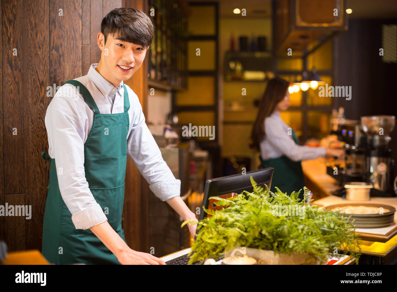 Make Waiters Make it waitress and waiter in cafe Stock Photo - Alamy