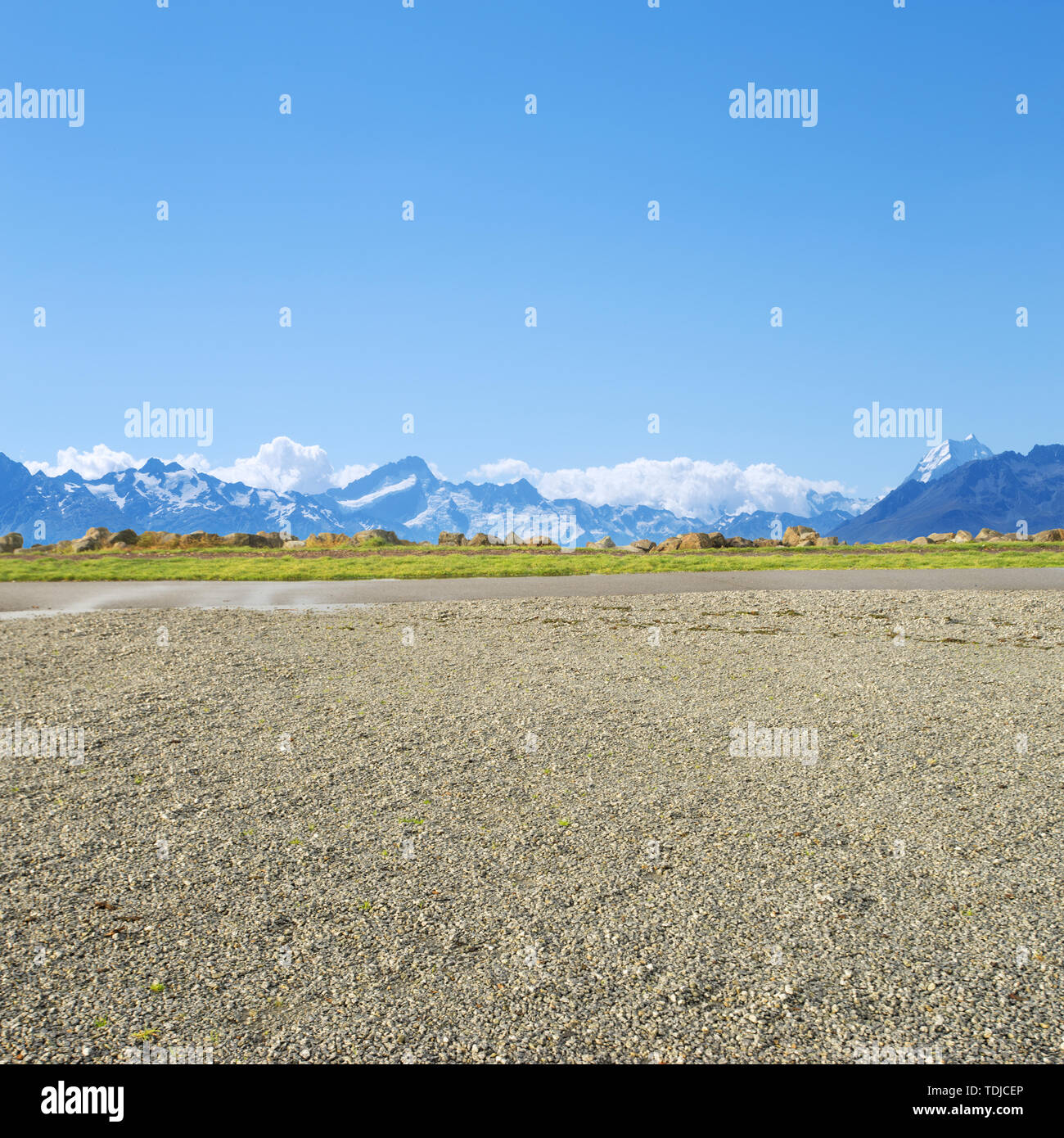 empty rural road near snow mountains in fine day in new zealand Stock Photo