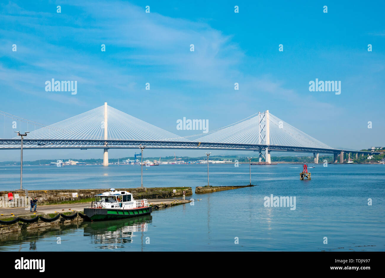 Forth Road Bridge and Queensferry Crossing on sunny day, view from South Queensferry with pier, Scotland, UK Stock Photo